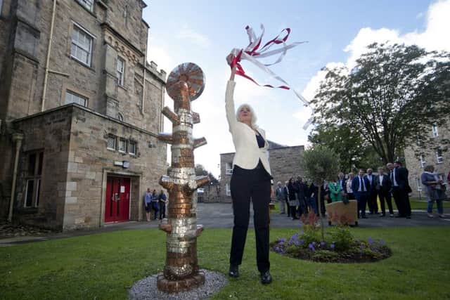 Paula untied the Latvian colours on the Tree of LIfe which she gifted the college.