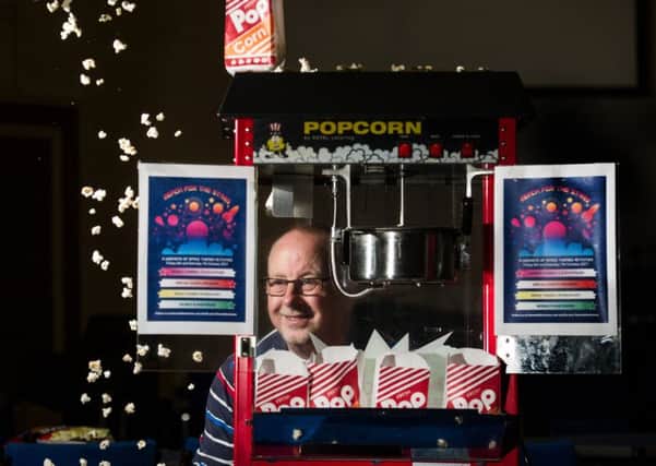 Craig Crosthwaite sells popcorn to help fund the film screenings. Picture: John Devlin
