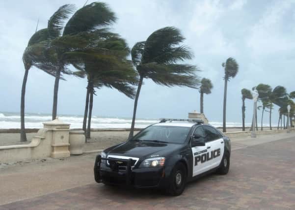 A police car patrols the beach in anticipation for Hurricane Irma, in Hollywood, Fla. (Paul Chiasson/The Canadian Press via AP)