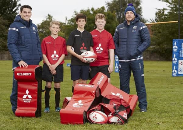 Sam Hidalgo-Clyne, left, and Hamish Watson, right, with some of the Trinity rugby players