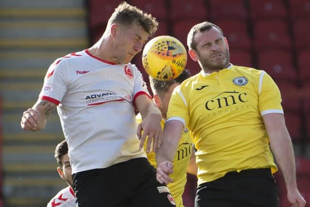 Craig Beattie, right, challenges for the ball at Broadwood