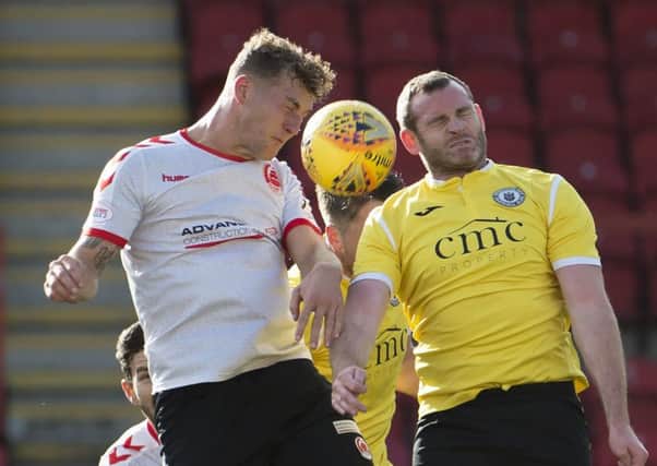 Craig Beattie, right, challenges for the ball at Broadwood