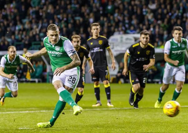 Anthony Stokes strokes home the winning penalty for Hibs. Pic: SNS