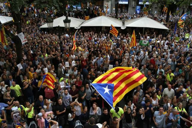 A crowd of protestors gather outside the Catalan region's economy ministry building in Barcelona. Picture AP