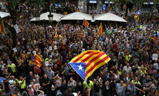 A crowd of protestors gather outside the Catalan region's economy ministry building in Barcelona. Picture AP