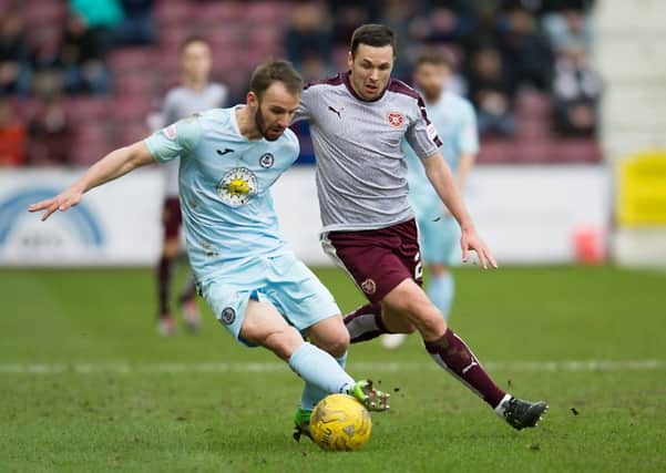Don Cowie of Hearts and Partick's Sean Welsh battle for possession at Tynecastle last year. Picture: John Devlin