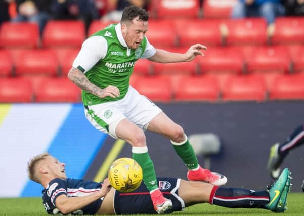 Hibs midfielder Danny Swanson tangles with Ross County's Jamie Lindsay during the Betfred Cup group match. Picture: SNS Group