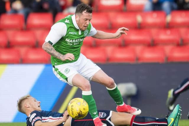 Hibs midfielder Danny Swanson tangles with Ross County's Jamie Lindsay during the Betfred Cup group match. Picture: SNS Group