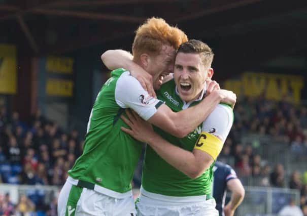 Simon Murray grabs hold of matchwinner Paul Hanlon, right, after his goal