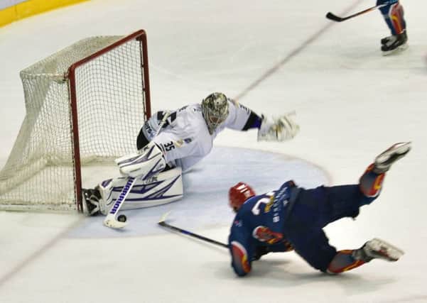 Capitals player Aaron Robertson takes a tumble trying to outwit Clan netminder Ryan Nie. Pic: Jan Orkisx/SMP