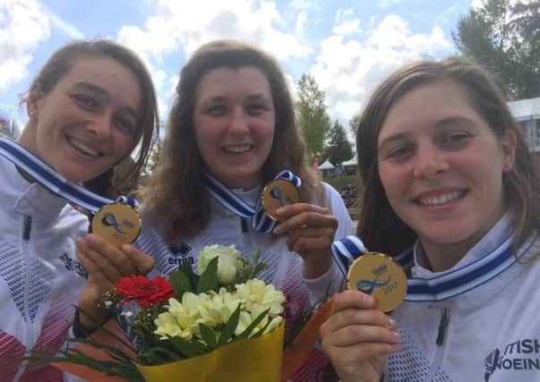 Eilidh Gibson, centre, shows off her gold medal with her team-mates