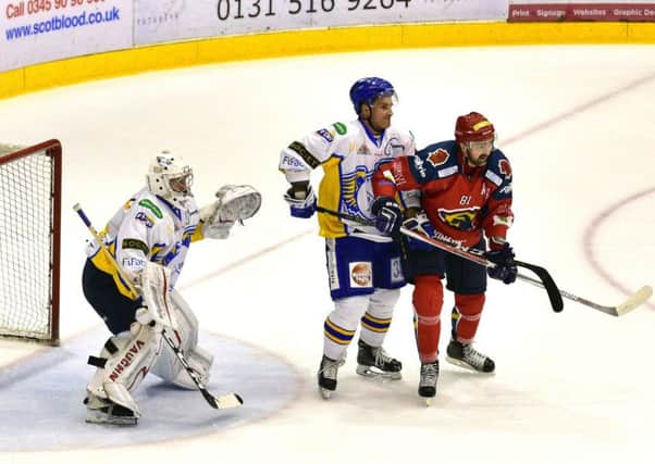 Returning Capitals forward Pavel Vorobyev, right, makes a nuisance of himself at the Fife goal. Pic: Jan Orkisz/SMP