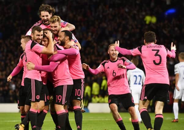 Scotland's players celebrate after the winning goal. Picture: SNS