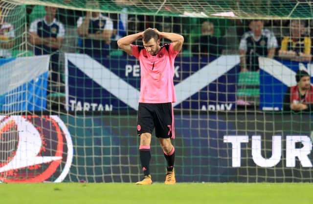 Dejection for Scotland and James McArthur as they fail to secure the three points necessary. Picture: PA