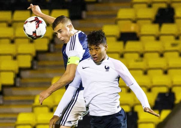 Ryan Porteous heads the ball against France Under-19s