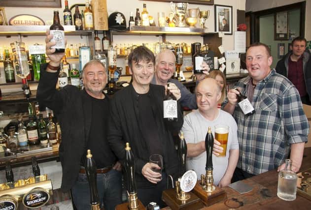 Ian Rankin pulling the first pint of Leith heavy at the Oxford bar with left, Len Cumming, landlord Harry Cullen and Steven Hope (far right) and pub goers