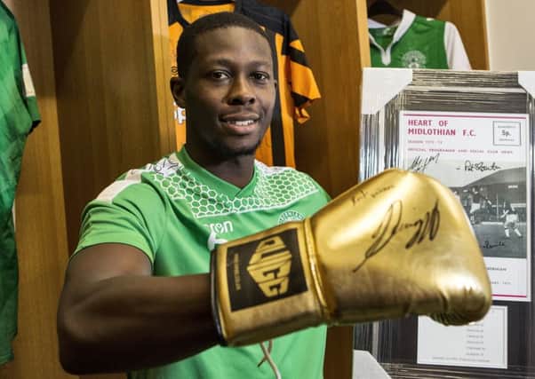 Marvin Bartley shows off the signed gloves donated by world heavyweight champion Anthony Joshua