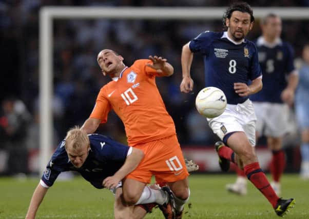 Paul Hartley takes advantage as Wesley Sneijder and Steven Naismith tangle at Hampden in 2009. Picture: Ian Rutherford