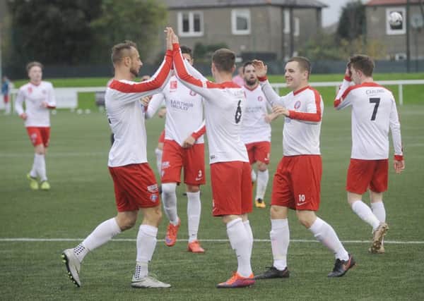 Spartans' players celebrate their second goal. Pic: Greg Macvean