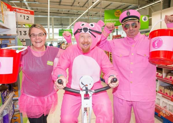 Sharon Laing, Gary Anderson and Stewart Munro are pretty in pink at Asda Chesser. Picture: Ian Georgeson