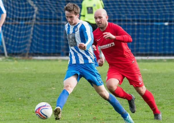 Lewis Barr takes control for Penicuik. Pic: Ian Georgeson