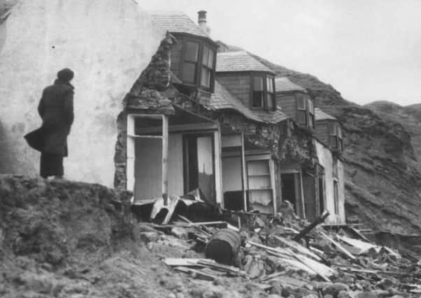 The front of houses ripped off by the waves in Gardenstown, Aberdeenshire, during the storm in 1953. PIC: Contributed.