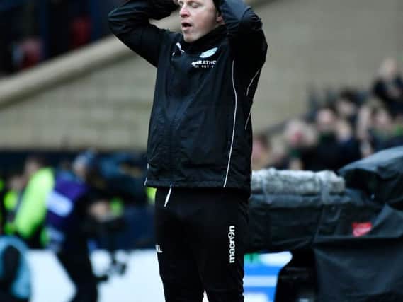 Hibs boss Neil Lennon  holds his head in  despair as he watches his side lose two first half goals