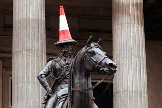 A traffic cone on the head of the Wellington statue outside the Gallery of Modern Art in Glasgow