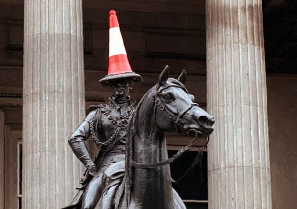 A traffic cone on the head of the Wellington statue outside the Gallery of Modern Art in Glasgow