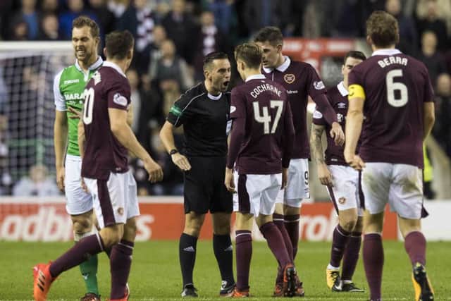 Referee Andrew Dallas has a strong word with Hearts kid Harry Cochrane