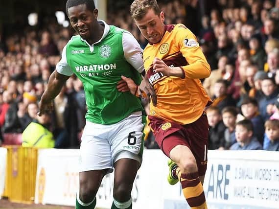 Hibs midfield enforcer Marvin Bartley battles with Motherwell's Elliott Frear at Fir Park this afternoon