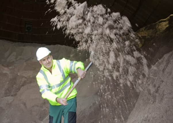 Edinburgh Council's preparation for winter - Fraser Stewart, a depot roadman, shovelling road salt