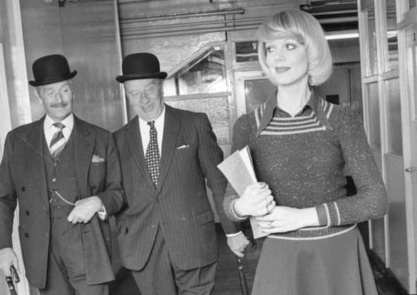 A secretary in a mini-skirt catches the eye of bowler-hatted businessmen in the sexist 70s. Picture: Getty