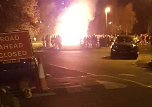 A car goes up in flames on a night of carnage in the Capital