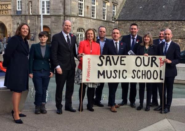 MSPs gather outside the Scottish Parliament with campaign lead Lindsay Law and  City of Edinburgh Music School students to show cross-party support for the school yesterday