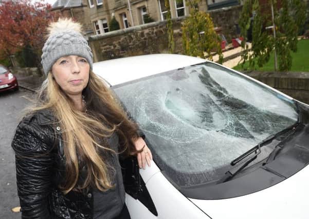 Lynne Lineen's car had its windscreen smashed by youths. Picture: Greg Macvean