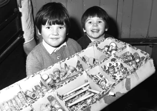 Edinburgh sisters Joan and Donna Pattie look forward to Bonfire Night in 1967 with a box of fireworks