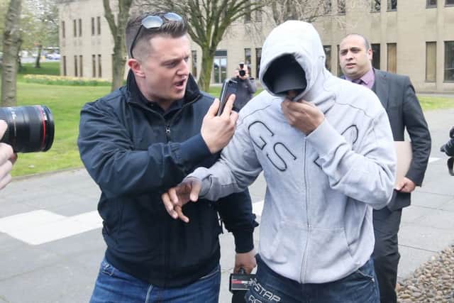 Former EDL leader Tommy Robinson (centre) films an unidentified man arriving at Huddersfield Magistrates Court