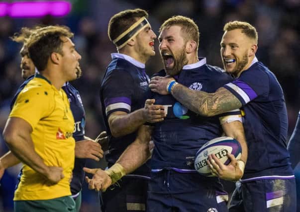 John Barclay (centre) celebrates his try with Byron McGuigan (right) and Stuart McInally