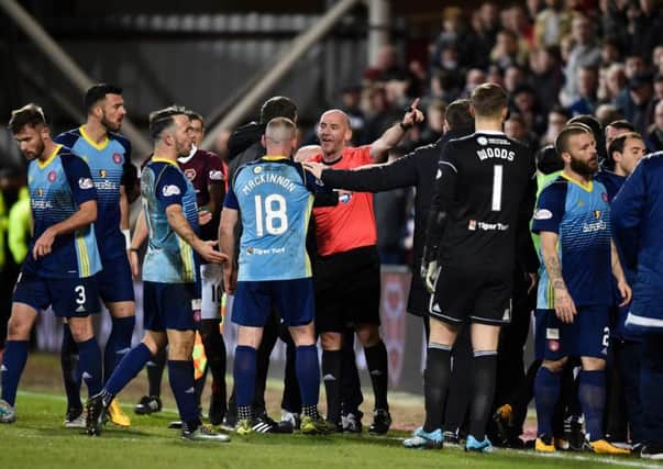 Referee Bobby Madden tries to restore order during the second half between Hearts and Hamilton at Tynecastle Park