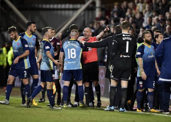 Referee Bobby Madden tries to control proceedings after sending Hearts assistant Austin MacPhee to the stand. Pic: SNS