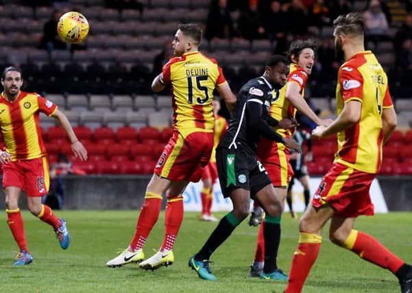 Partick Thistle's Adam Barton scores an own goal to give Hibs the lead. Pic: SNS