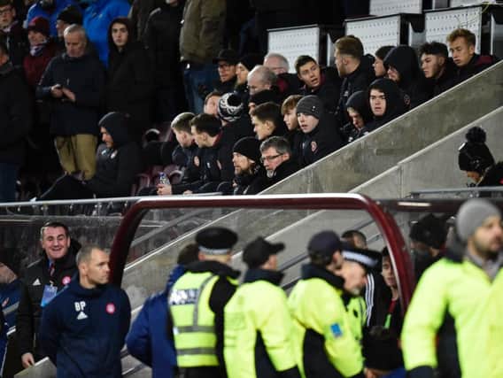 Hearts manager Craig Levein and his assistant Austin MacPhee sit together behind the home dugout after referee Bobby Madden took action
