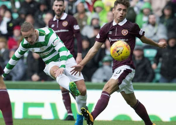 Leigh Griffiths gets a shot away under pressure from Jamie Brandon during Hearts' trip to Celtic in August. Picture: SNS Group