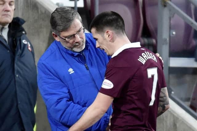Hearts manager Craig Levein speaks with Jamie Walker as the midfielder leaves the pitch