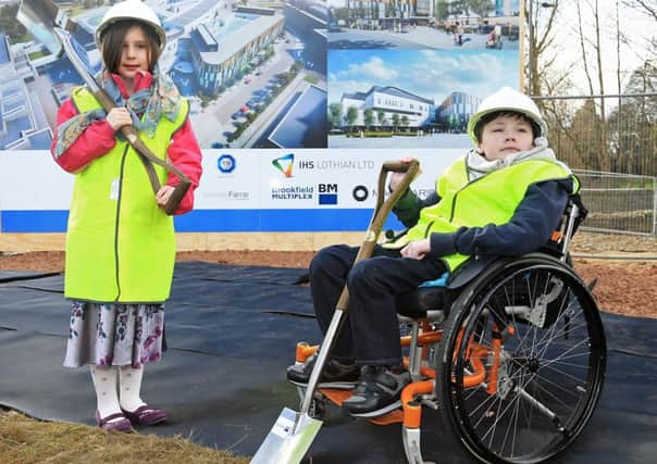 Patients Jos and Beau Rendall mark the official start of the construction at a sod cutting ceremony. Picture: Gordon Fraser