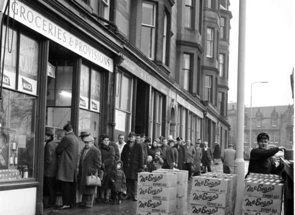 Customers queue outside Mr Munro's shop at Brandon Terrace in Edinburgh stocking up for Hogmanay. Picture: TSPL