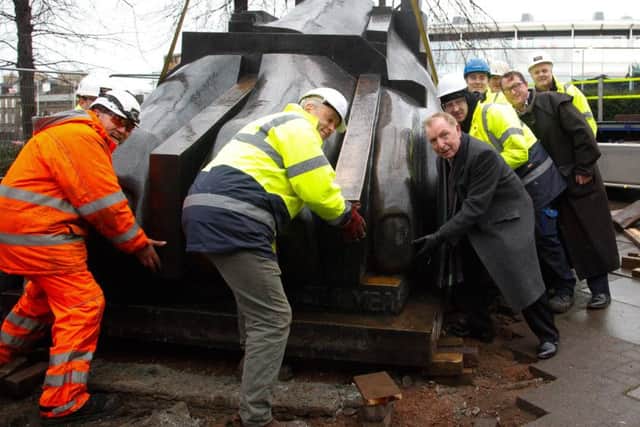 Tom Farmer lends a hand as the Paolozzi Sculptures are moved from outside St Mary's Cathedral at the top of Leith Walk. Picture: Scott Louden