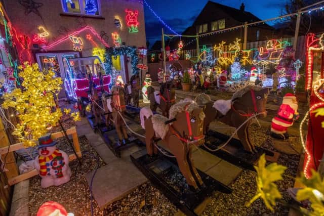 David Brown had decorated his house for nine years and dresses as Santa giving sweets to people for a donation to charity. Picture: SWNS