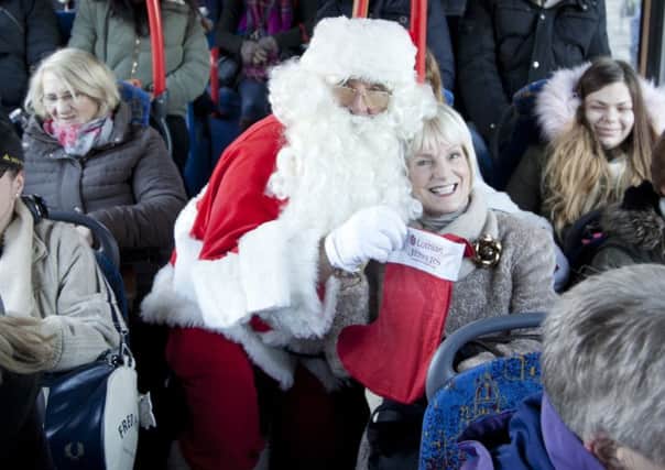 Santa was giving out stockings with Jenners gift cards and gifts on Lothian buses. Picture: Alistair Linford
